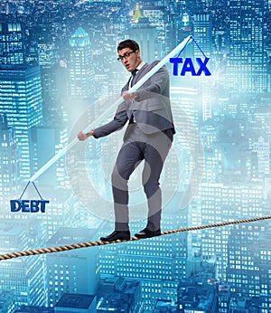 Businessman balancing between debt and tax