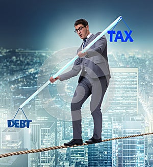 Businessman balancing between debt and tax