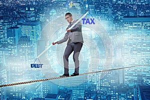 The businessman balancing between debt and tax