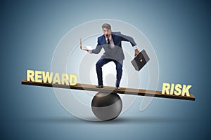 The businessman balancing between reward and risk business concept