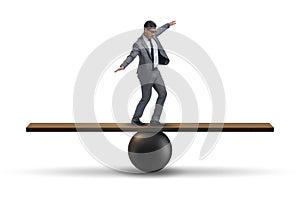 The businessman balancing on seesaw in uncertainty concept