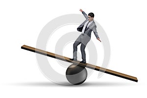 The businessman balancing on seesaw in uncertainty concept photo