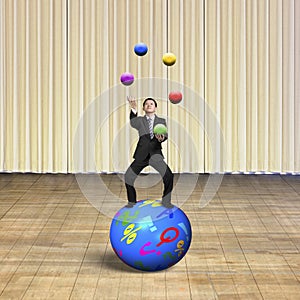 Businessman balancing on sphere juggling with balls