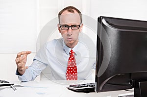 Businessman with bald and glasses aggressive and in rage sitting