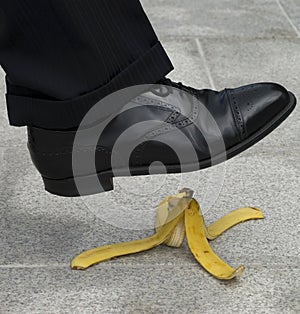Man stepping on banana peel, skin in street, work accident, danger