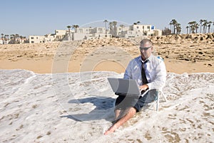 Businessman on beach working