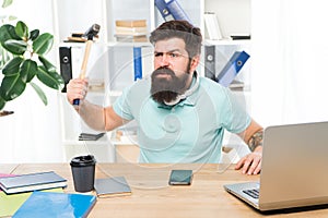 Businessman with beard and mustache gone mad with hammer in a hand. Angry aggressive businessman in office. Frustrated