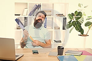 Businessman with beard and mustache gone mad with hammer in a hand. Frustrated office worker holding hammer poised ready