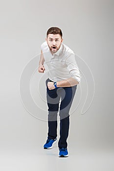 Businessman with beard in white shirt on position of start ready