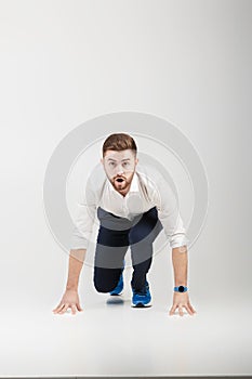 Businessman with beard in white shirt on position of start ready