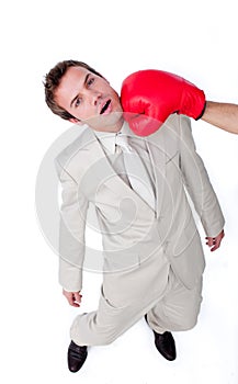 Businessman being hit with a boxing glove