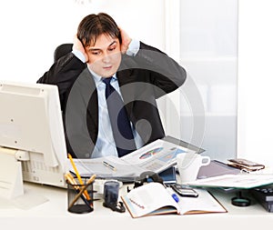 Businessman being overloaded with loads of work photo