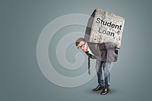 Businessman bending under a heavy stone with the words `Student Loan` written on it