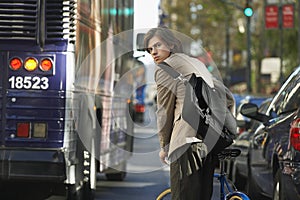 Businessman With Bicycle On Busy Street