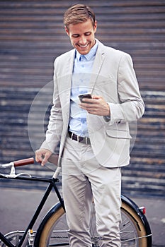 Businessman, bicycle and phone on street for internet, reading text and commute. Employee, bike and mobile app by