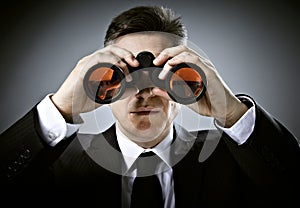 Businessman with binoculars. photo