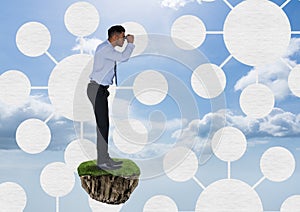 Businessman with binoculars on floating rock platform with interface mind maps in sky