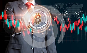 Businessman with Bitcoin currency and market exchange graphs