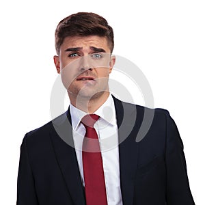 Businessman biting his lip and making a funny scared face