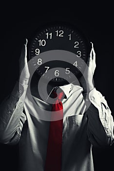 Businessman with black clock, deadline concept