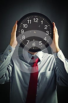 Businessman with black clock, deadline concept