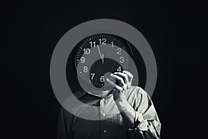 Businessman with black clock, deadline concept