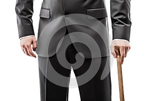 Businessman in black suit holding walking cane stick photo