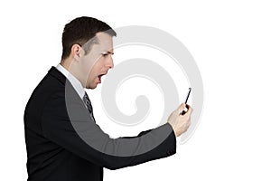 Businessman in Black Suit Holding Smartphone in Hand And Feeling Angry Against White Background