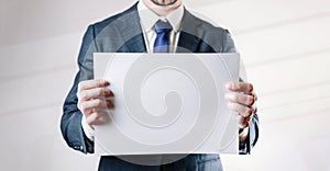 Businessman blank card. White blank board template holding business man on white background. Copy space empty poster.