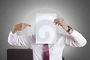 Businessman with Blank Paper Mask Covering His Face