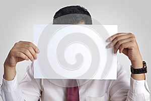 Businessman with Blank Paper Mask Covering His Face