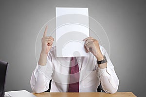 Businessman with Blank Paper Mask Covering His Face