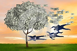 Businessman blown away from the money tree