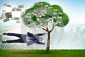 Businessman blown away from the money tree