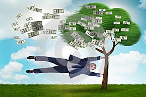 Businessman blown away from the money tree