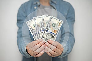 Businessman in blue shirt holds american dollars money on white background, closeup. Money, earnings, crediting and finance