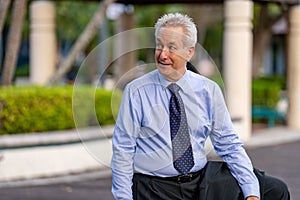 Businessman in a blue shirt and tie glancing over his shoulder