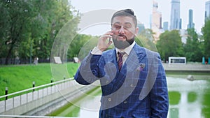 Businessman in blue suit discusses questions on phone