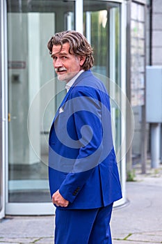 Businessman in blue suit in his 50s standing outdoors