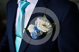 Businessman in blue suit tying the necktie. Smart casual outfit. Man getting ready for work.The morning of the groom