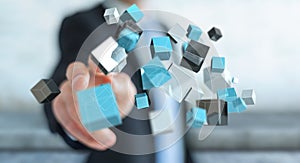 Businessman touching floating blue shiny cube network 3D rendering
