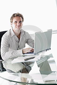 Businessman in boardroom with laptop