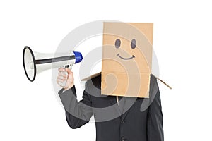 Businessman with box on head holding megaphone