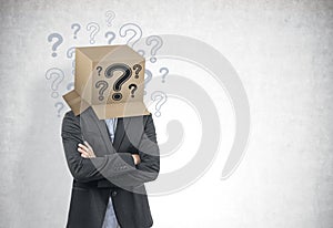 Businessman with a box on his head, question marks