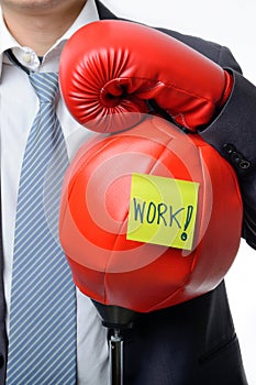 Businessman with boxing glove ready to fight with work, business