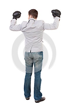 Businessman with boxing gloves in fighting stance.
