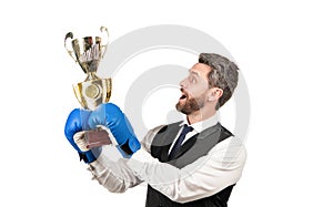 businessman in boxing gloves with trophy. successful ceo boxer. relentless struggle and success