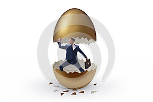 Businessman breaking out of golden egg