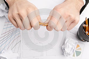 Businessman breaking pencil