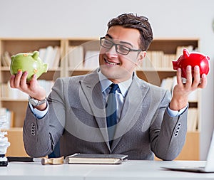 Businessman breaking piggybank in the office